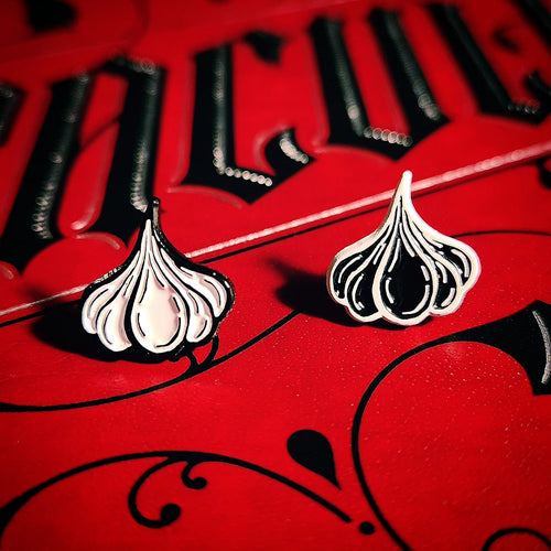 Two mini garlic enamel pins in black and white