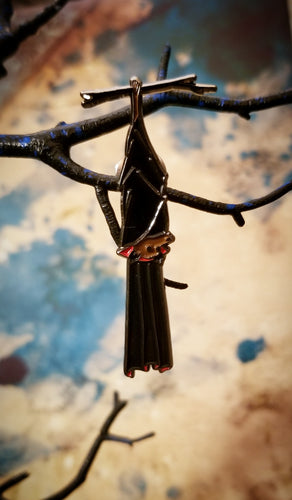 Bat pin hanging from tree